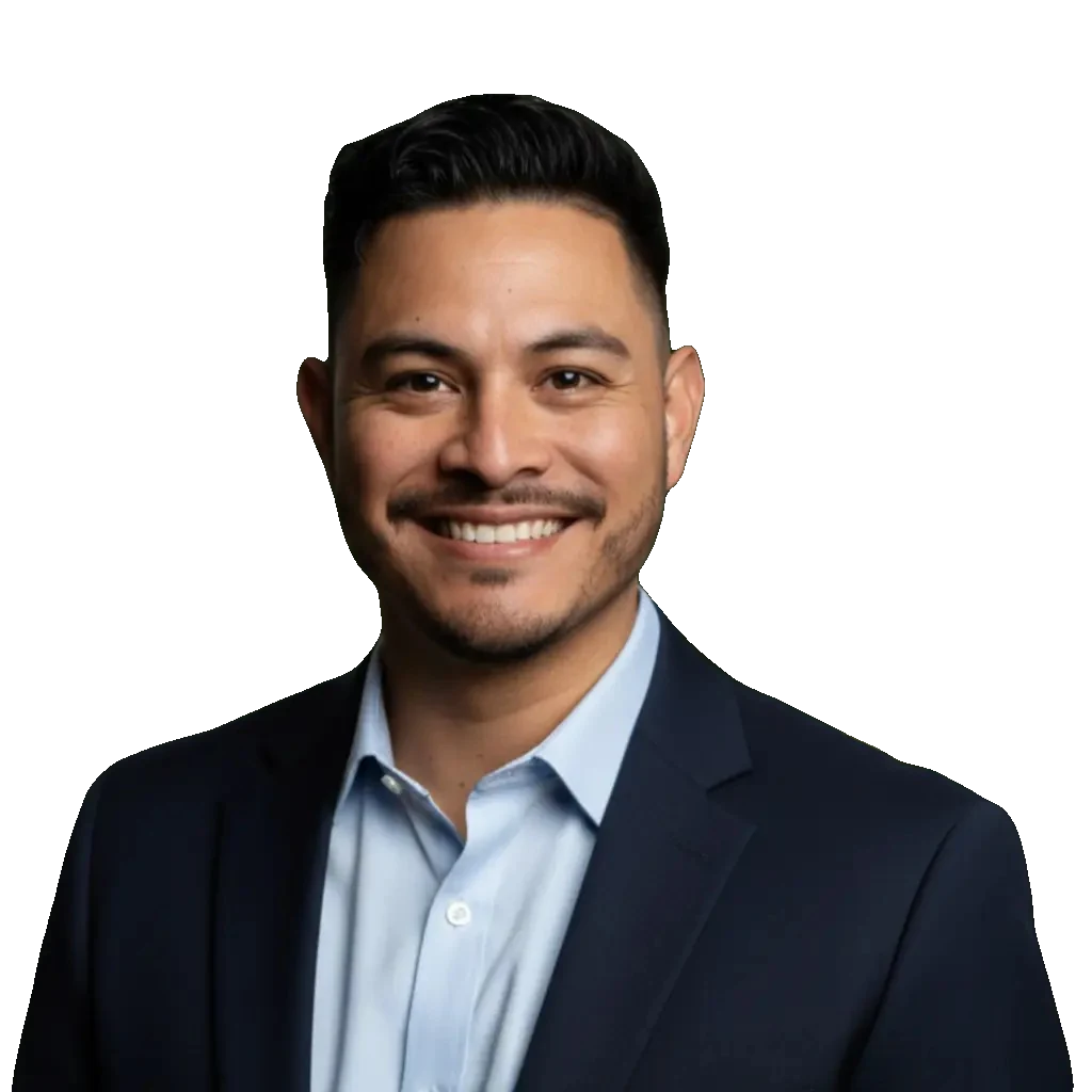 Oscar Tellez, smiling, in a navy suit jacket and a light blue open-collar shirt